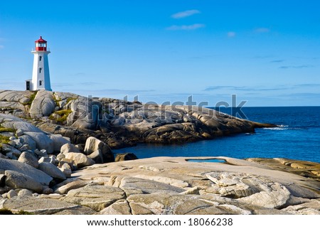 Heritage lighthouse on a rocky beach. Peggy\'s Cove, Canada.