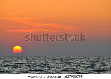 Similar – Image, Stock Photo Sunset sky over wavy sea with floating boats