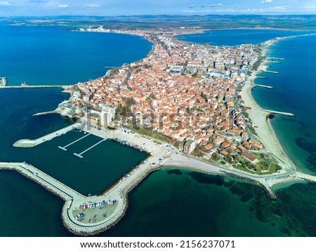 Panoramic bird's eye view over small ancient resort town of Pomorie with old European small houses and quiet calm empty streets, washed by the sea spring turquoise Black Sea on clear day in Bulgaria 商業照片 © 