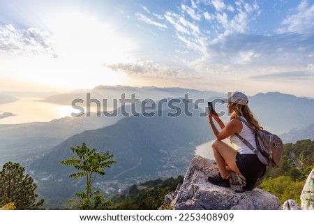 Similar – Image, Stock Photo Travelers taking photo on seaside at sunset