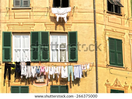 The laundry hanging in the sun on the outside of a house facade