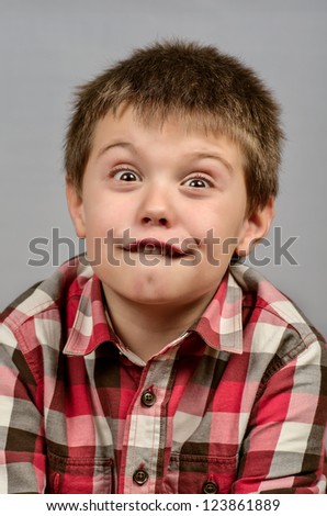 child making ugly faces in gray 11
