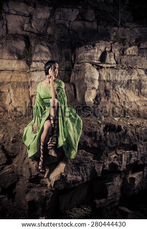 Elf woman on the rocks background.