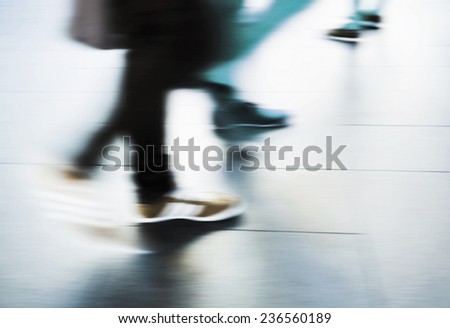 Abstract people are walking in the city. Motion blur.