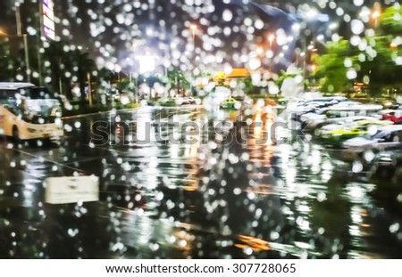 Blur background of car park on a rainy night