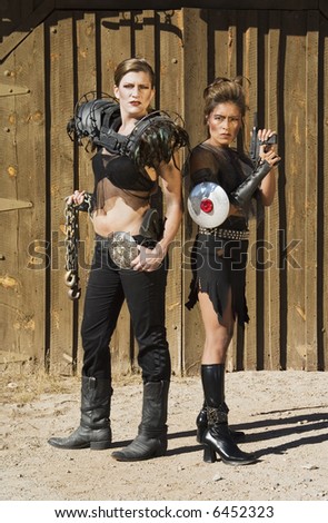 Tough science-fiction women in costumes with weapons.