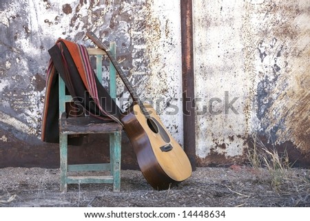 Acoustic Guitar Leaning Against a Chair in a Rustic Setting
