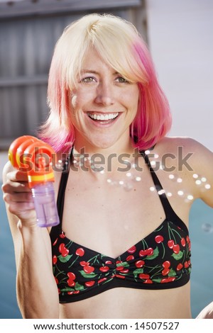 Woman in bikini with a bubble gun