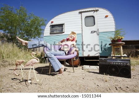 Pretty Woman in a Cowboy Hat in Front of a Travel Trailer
