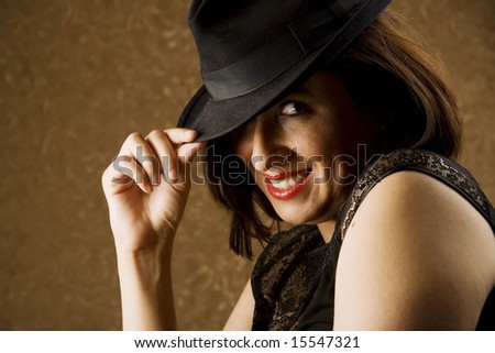 Pretty Hispanic Woman Tipping Her Fedora Hat