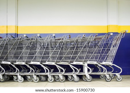 Line of old style shopping carts outside a supermarket