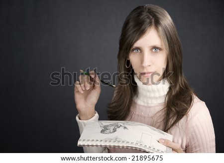 Pretty female artist with pencil and drawing pad