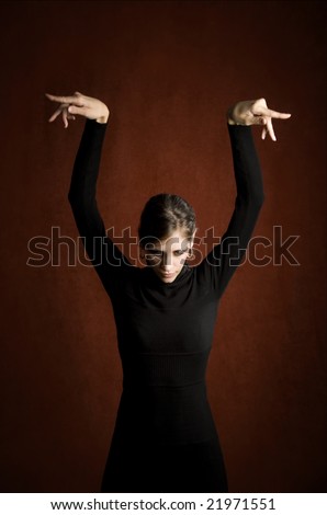 Pretty Woman in a Stretchy Knit Black Dress with Hands Over Her Head