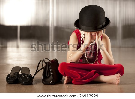 Young girl with her face hidden in her hat