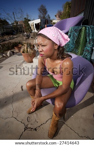 Black woman in front of house with messy yard