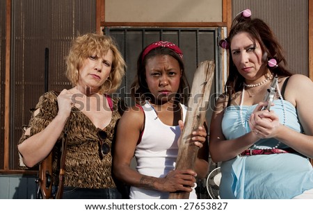 Three rough women on a house step