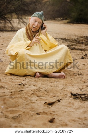 Wise Man in the Desert Talking on Cell Phone