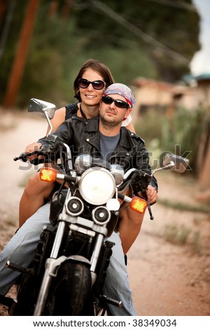Man and Woman riding on vintage motorcycle