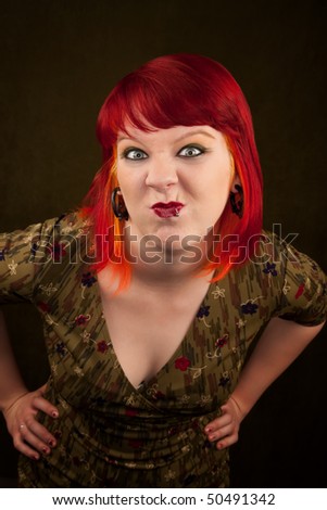 Pretty punky girl with brightly dyed red hair