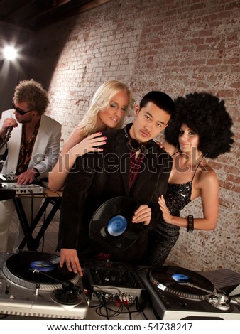 Handsome Asian DJ at a 1970s Disco Music Party