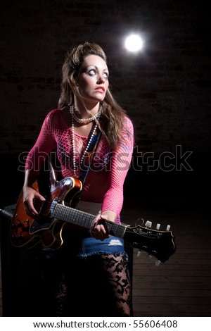 Young punk rocker tunes waits for cue to tune her guitar