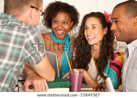 A group of friends are talking and smiling with each other.  Horizontal shot.