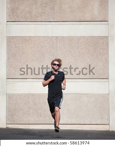 Handsome, young man runs for exercise.