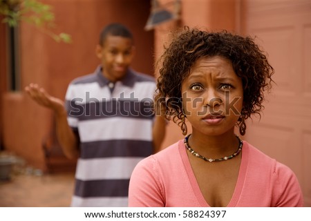 Confused single-parent with son outdoors in front of house