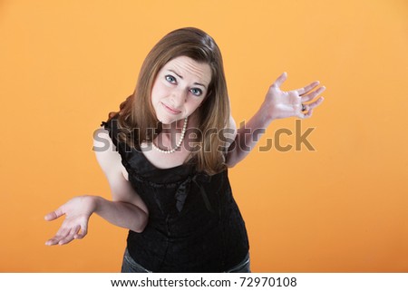 Young Caucasian woman on an orange background wonders why