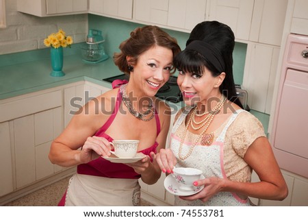 Two retro housewives with tea in a kitchen
