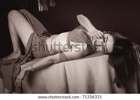 Beautiful Arab woman lying down with hand on face