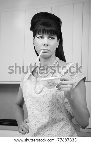 Tough housewife in apron with cigarette and coffee cup