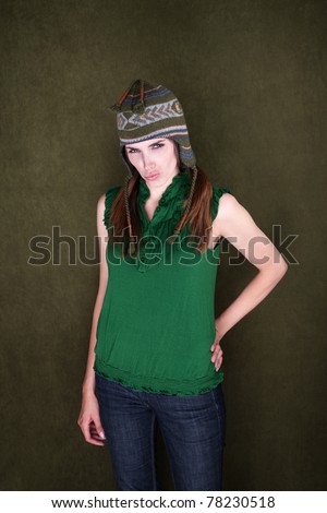 Sassy young Caucasian woman in short sleeves and sock monkey cap