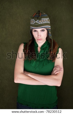 Woman with folded arms and sock monkey cap folds her arms