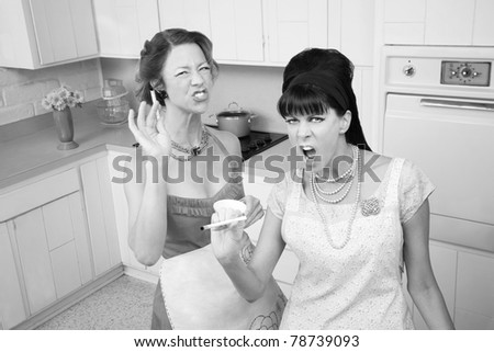 Two sassy housewives smoking cigarettes in the kitchen