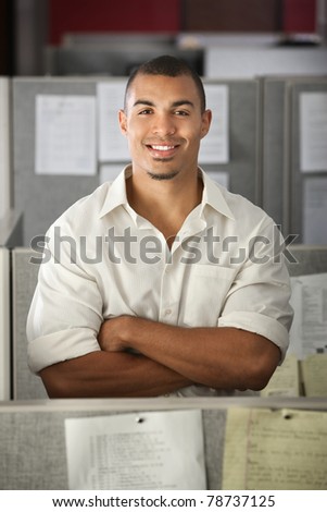 Confident Black male office worker with his arms folded