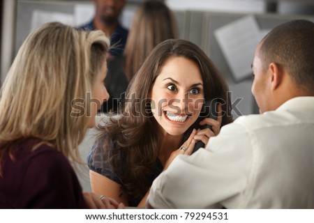 Excited woman office worker with colleagues on phone