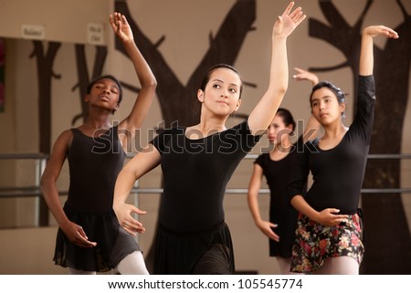 Four cute Black and Latina dance students rehearsing