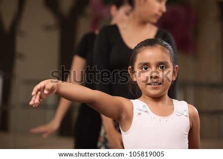 Cute young ballet student practicing in a dance studio