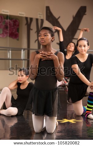 Group of young female ballet dancers waiting at rehearsal