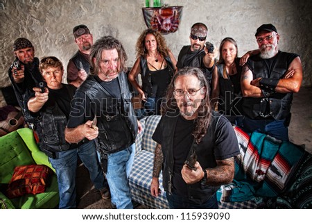 Group of nine biker gang members in leather jackets indoors