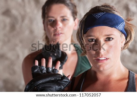 Sexy duo of women holding kettle bell weights