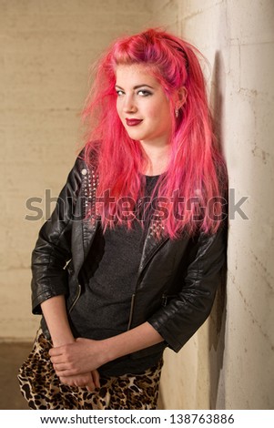 Single young woman with pink hair leaning back