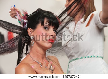 Pouting lady with hair straightened in hair salon