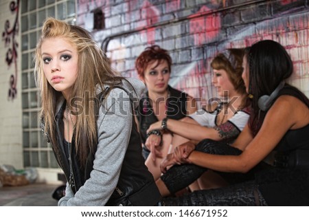 Teenager with low self-esteem near three friends