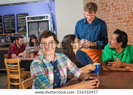 Grinning woman with friends in coffee house