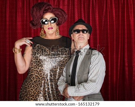 Tall drag queen and retro style man in sunglasses