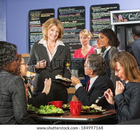 Restaurant owner with group of unhappy customers
