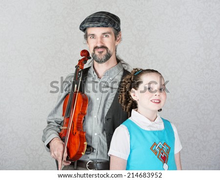 Irish folk music parent holding violin with cute child