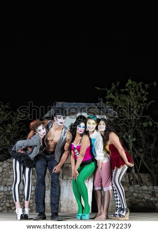 Clown ensemble posing on outdoor theater stage